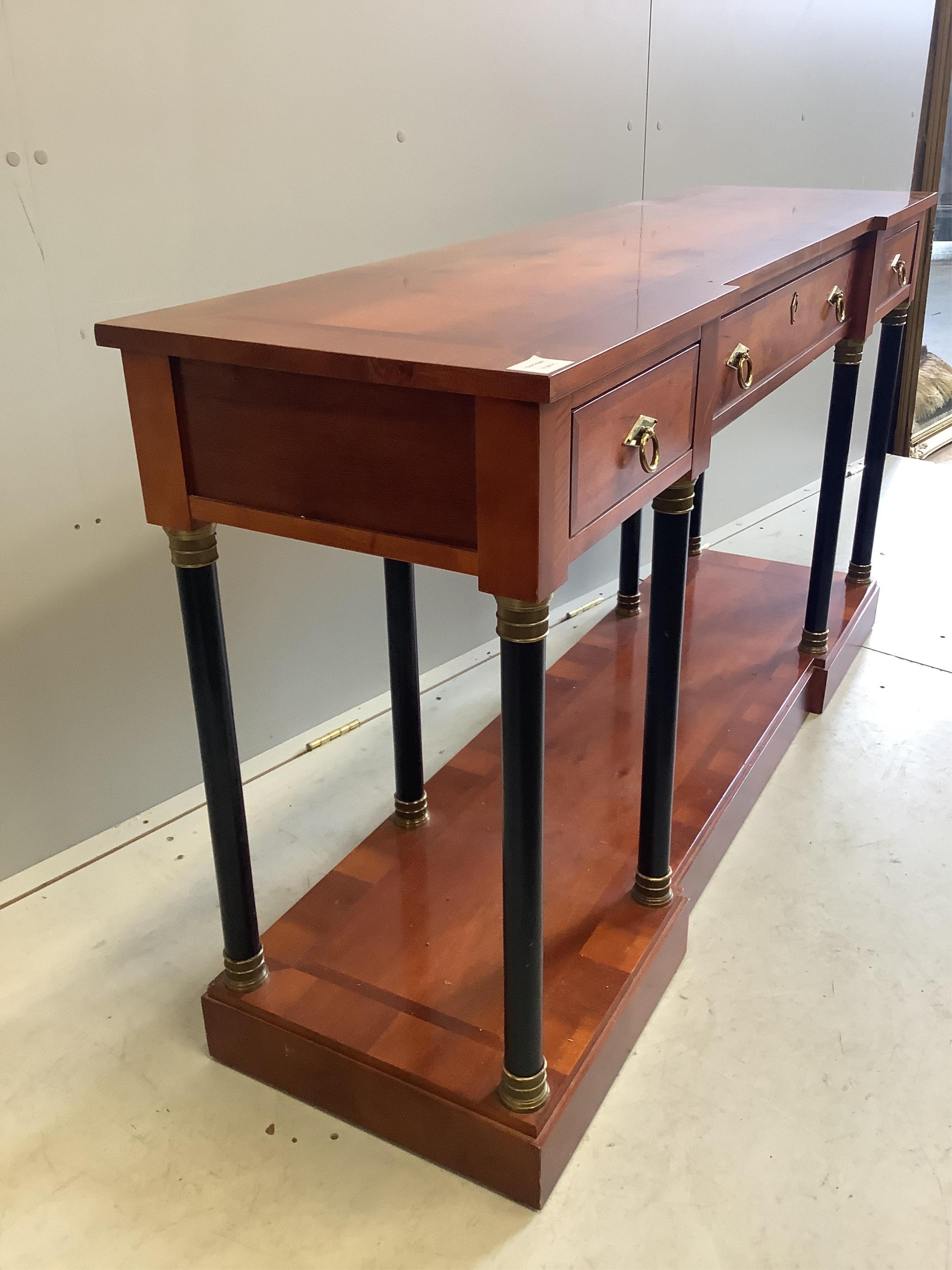 A French Empire style mahogany and ebonised three drawer console table, width 147cm, depth 41cm, height 79cm. Condition - fair to good